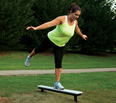Woman working out on a Balance Plank at an Outdoor Fitness Park