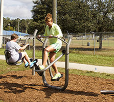 Woman working out on a Cardio Walker at an Outdoor Fitness Park