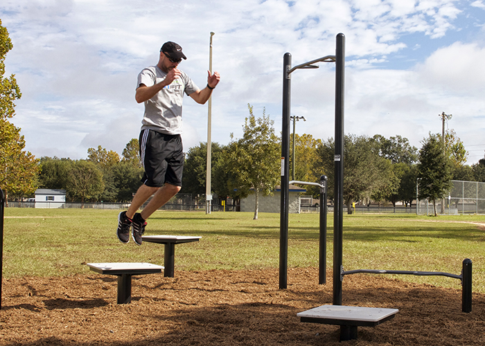 Man Exercising on Plyometric Boxes at an Outdoor Fitness Park
