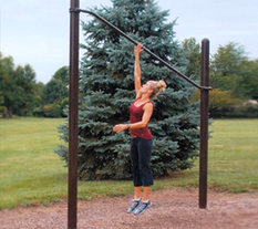 Woman working out with a High Jump at an Outdoor Fitness Park