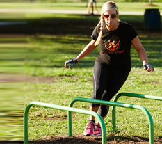 A Woman exercising with Hurdles at an Outdoor Fitness Park