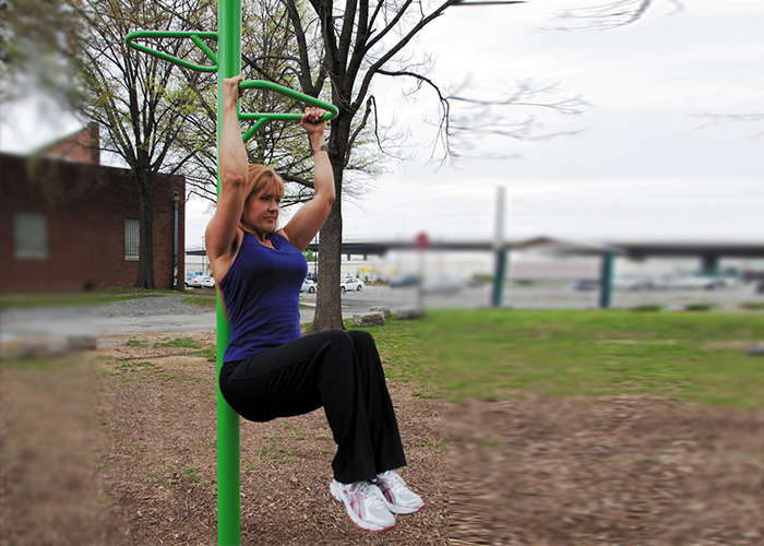 Woman Exercising on a Knee Lift at an Outdoor Fitness Park