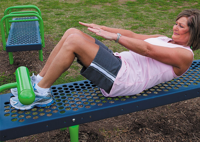 Woman doing a sit-up on Fitness Park sit-Up machine
